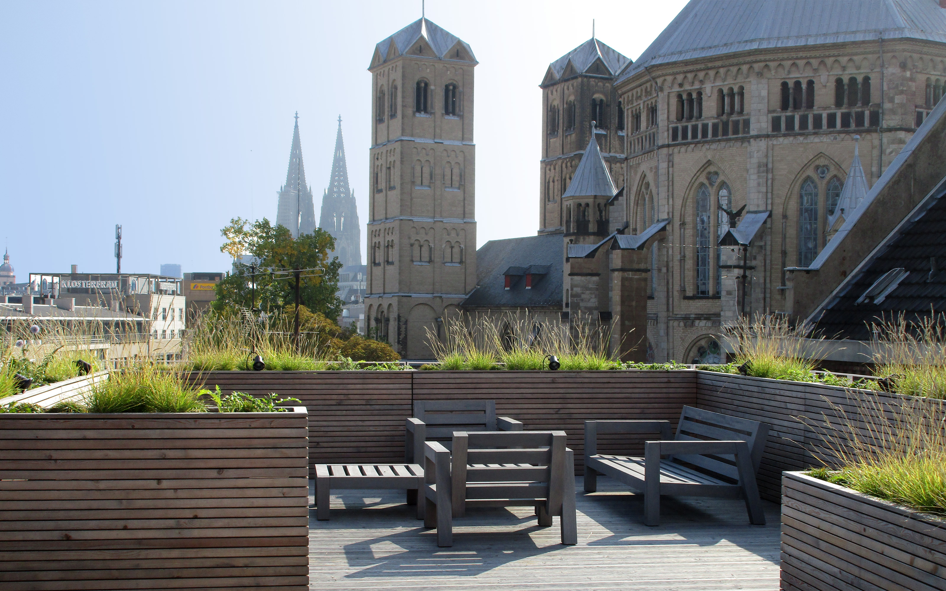 Pflanztröge umschließen einen Sitzbereich auf einer Dachterrasse