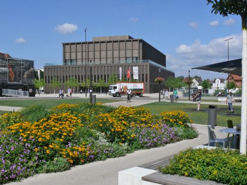 Park mit Spazierwegen, Rasenflächen und blühendem Staudenbeet