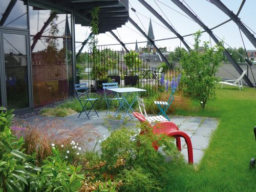 Dachgarten mit Terrassenfläche unter Stahlkuppel 