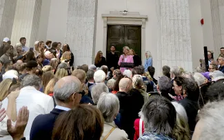 Der Deutsche Pavillon der Architekturbiennale widmet sich den Möglichkeiten klimaresilienter Stadtplanung. Sprecherin hält eine Rede vor einer Menschengruppe
